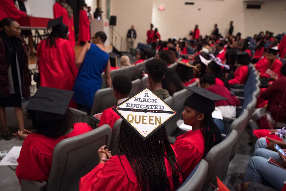 A student wears a decorated grad cap that reads A Black Educated Queen