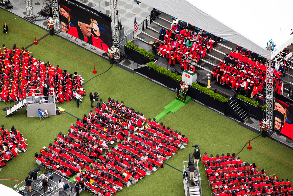 A bird's eye view of the graduates and stage