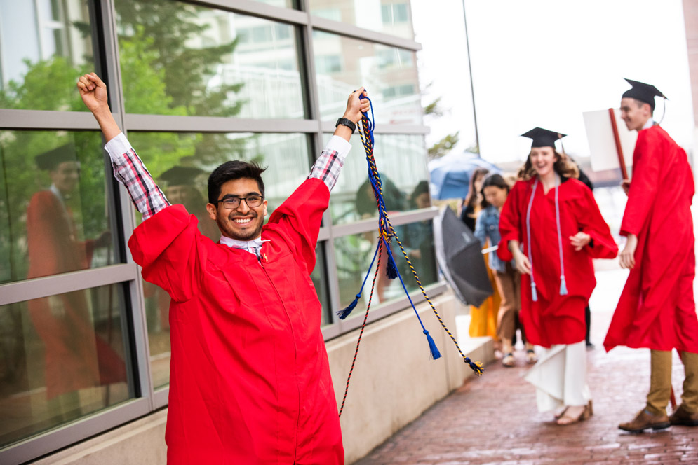 An excited student holds his cords