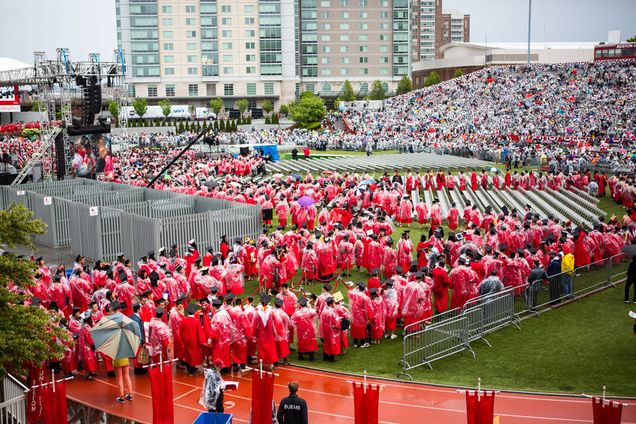 graduates in rain gear process onto Nickerson Field
