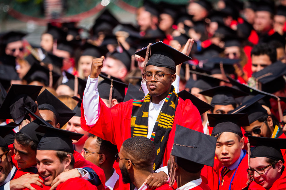Graduates clap, cheer, and hug
