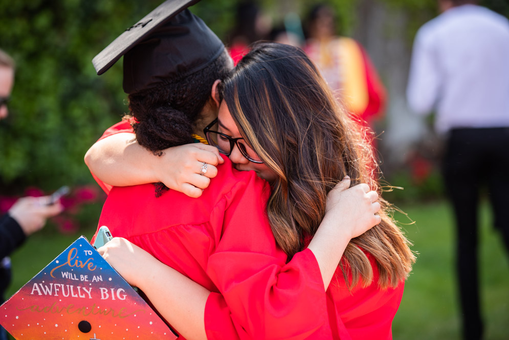 Girls embrace after the ceremony ends