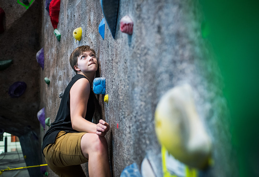Kayla Furbish climbing the rock climbing wall at the BU Fitness and Recreation Center.