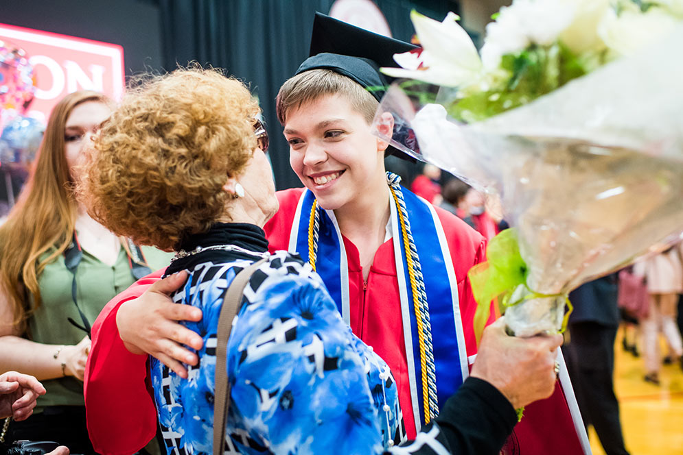 Kayla hugs a family member after the 2019 Boston University College of Arts and Sciences convocation.