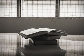 Stack of books on a table in a prison