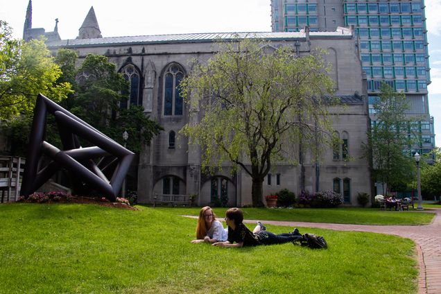 From left to right, two friends Lily Bryant (CAS'22) studies political science, and Faith Puleikis (CAS'20), studies neuroscience, decide to step outside of their dorms to enjoy some afternoon sunshine on campus