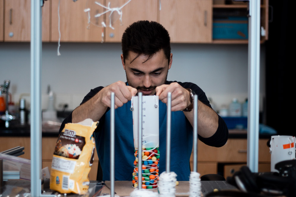 Armen Guerra building a tower out of m&ms and other materials