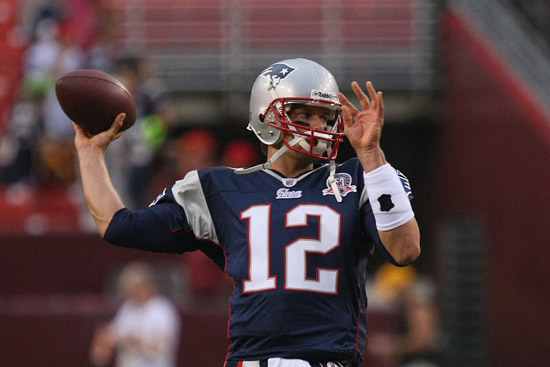 Tom Brady about to throw a football