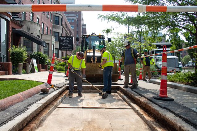Constuction workers continue sidewalk placement along Commonwealth Ave
