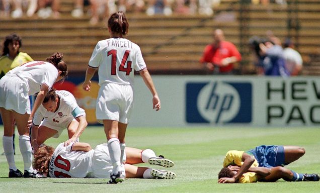 US midfielder Michelle Akers and Brazil's Grazielle lie injured after going up for a header at the Women's World Cup semi-final match between the US and Brazil 04 July, 1999.