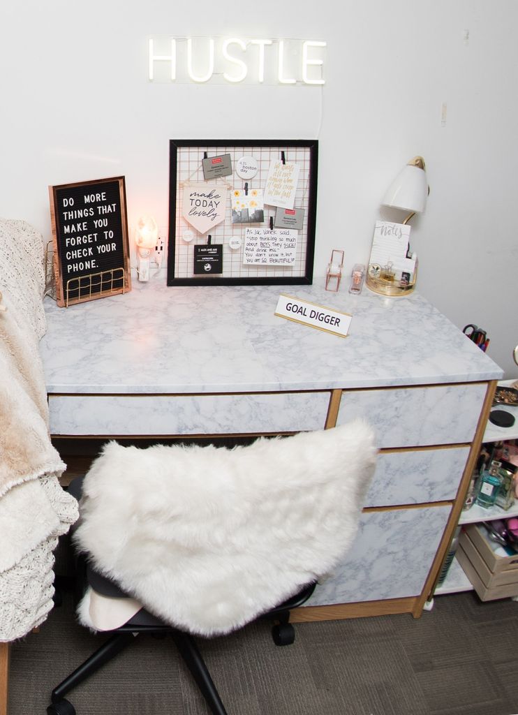 A desk chair with a fluffy white covering