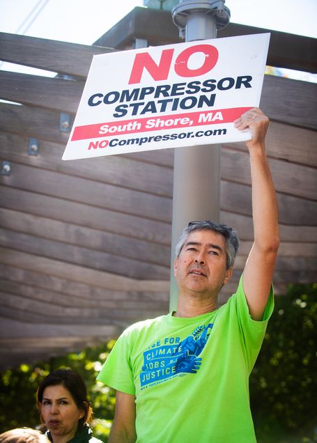 Professor Nathan Phillips holds a sign that says 'No Compressor Station South Shore, MA. NoCompressor.com' at the Youth Climate Strike on Boston City Hall plaza.