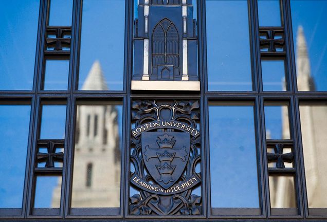 Photo of the BU seal on a windowpane in Marsh Plaza