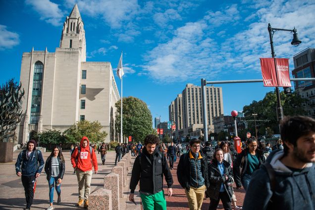 Studnets walk down Comm Ave with Marsh CGS in the backgrounc