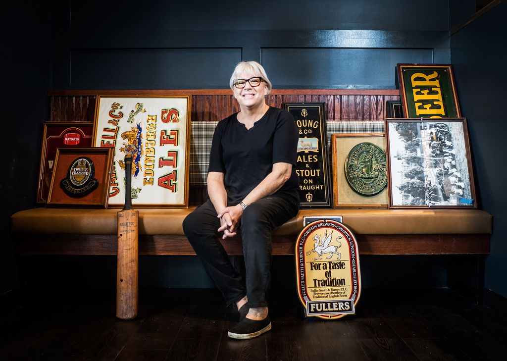 Pam Beale, Cornwall's owner, sits on a bench along with miscellaneous memorabilia
