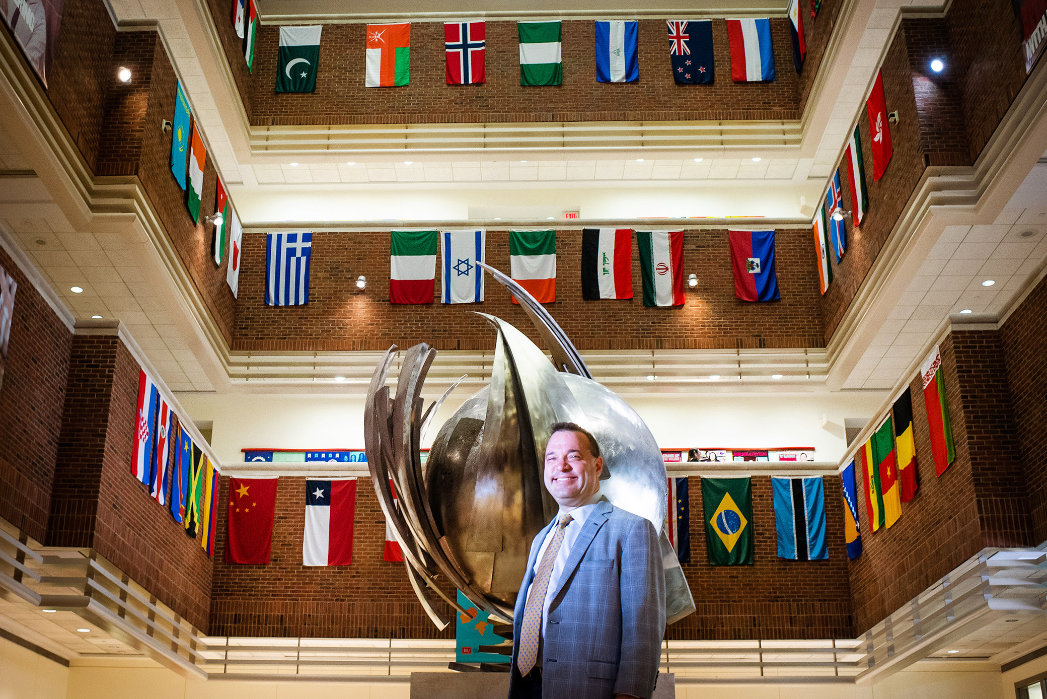 Greg Stoller stands in the Questrom Buisness school lobby