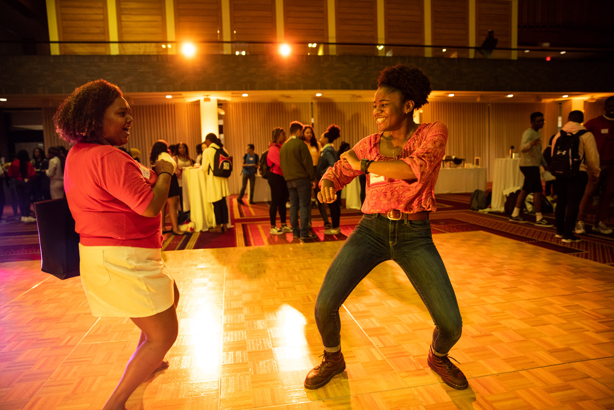 two women dance at the Black Community Reception in the GSU Metcalf Ballroom