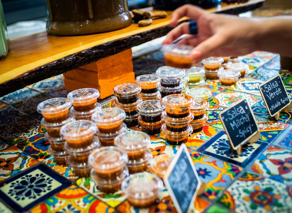 A variety of homemade salsas in clear containers