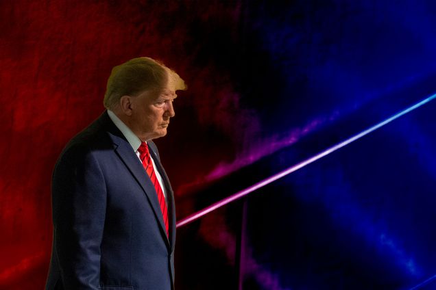 Donald Trump looking pensive in front of a textured red-blue gradient background.