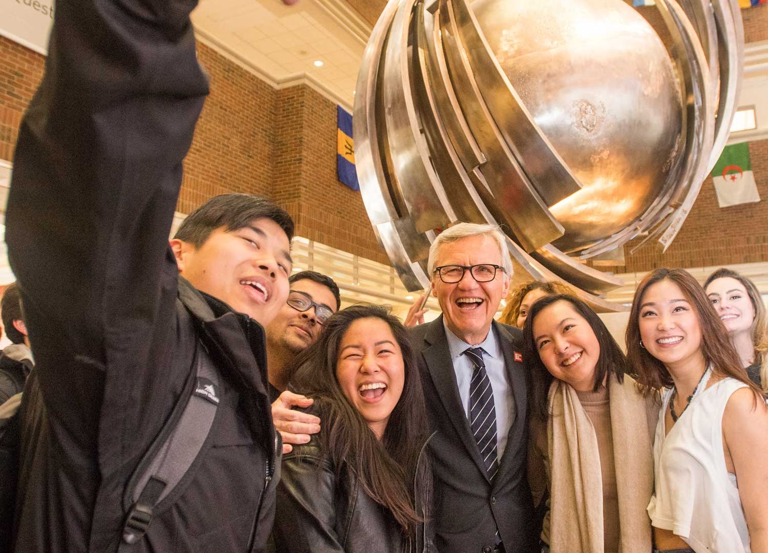 Allen Questrom poses with Boston University Questrom School of Business students after the ceremony announcing the renaming of that school in 2015.