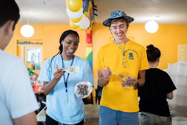 Two First Year Outreach Project (FYSOP) make paper lanterns during FYSOP week at Spontaneous Celebrations in Jamaica Plain for their paper lantern festival.