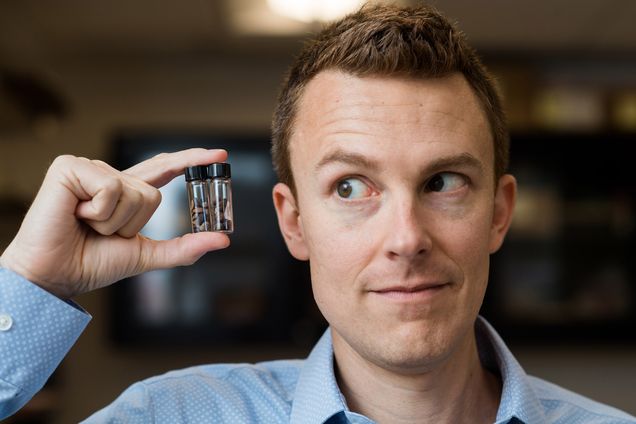 Archaeologist John "Mac" Marston holds a vile of ancient seeds found at an archaeological dig.