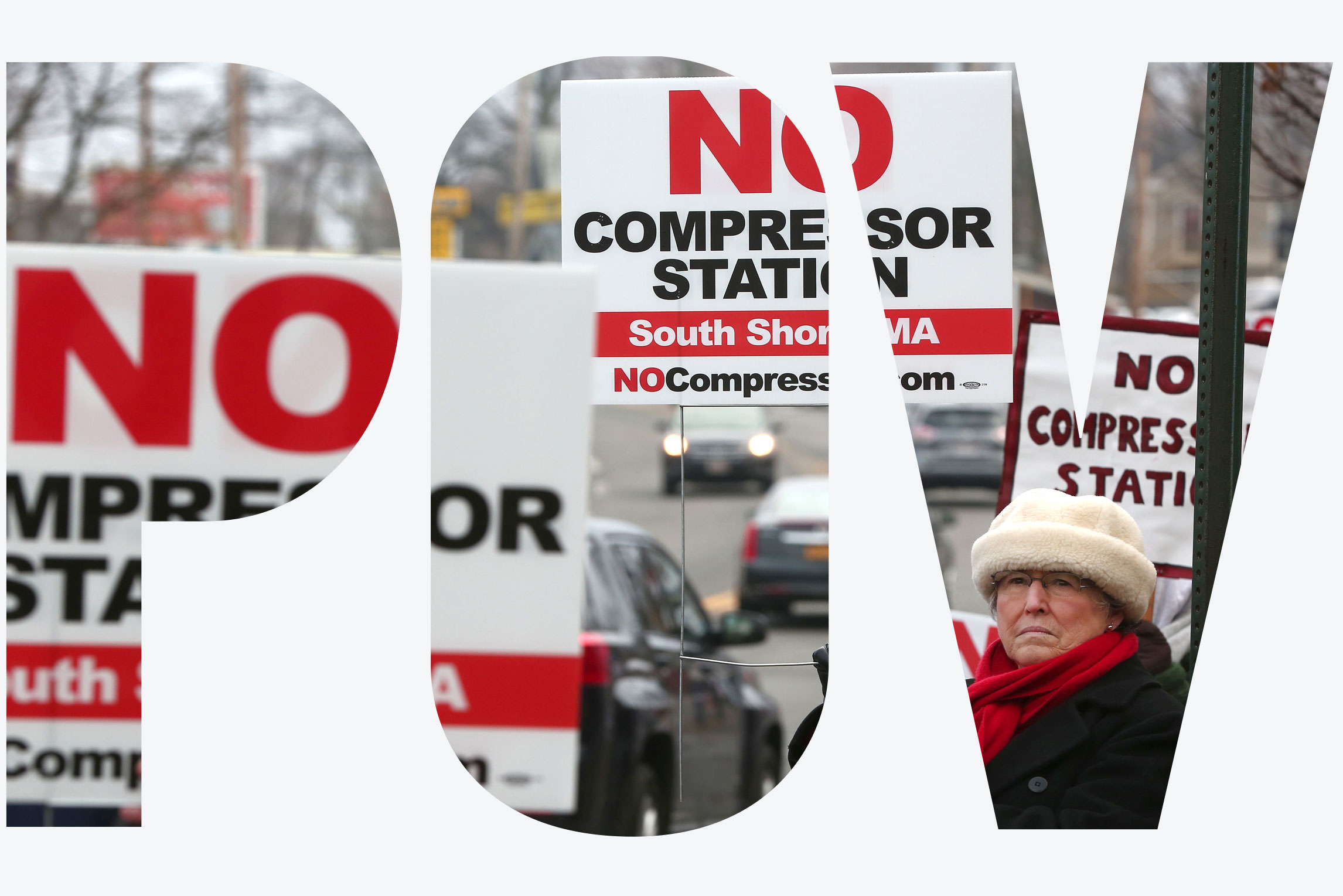 People hold signs protesting a proposed natural gas compressor station in Weymouth, Massachusetts.