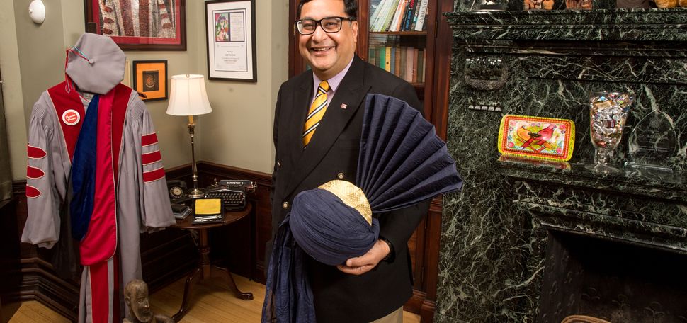 Adil Najam, Pardee School Dean, stands in his office