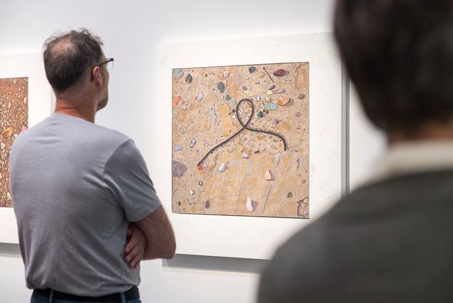 A visitor admires the Jps[hine Halvorson painting “Ground View: Gasket” at the Boston ICA.