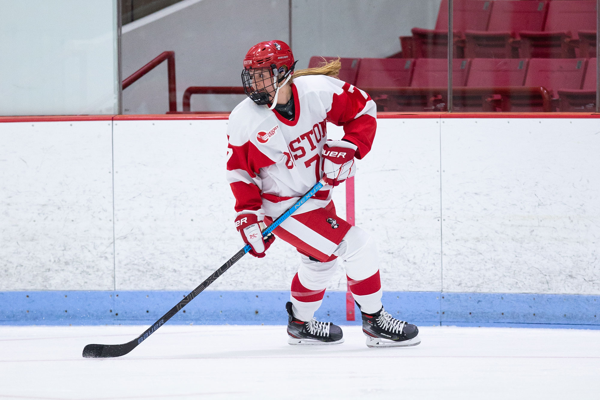 Boston University Terriers women's hockey forward Jesse Compher handles the puck during a game.