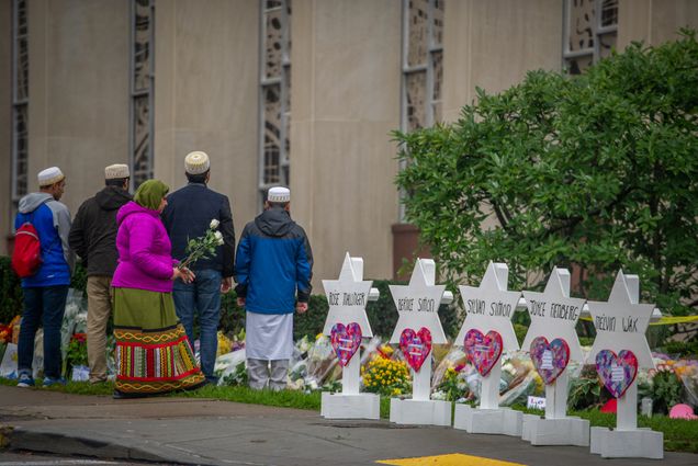 Samina Mohamedali prepares to place flowers on a memorial in front of the Tree of Life Congregation