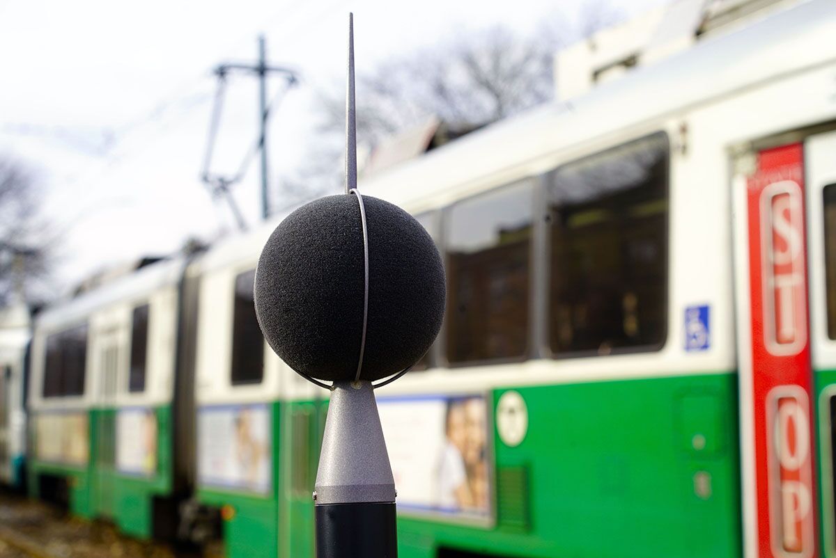 One of eight rotating sound stations deployed by the School of Public Health Community Noise Lab with an MBTA Green Line train in the background.