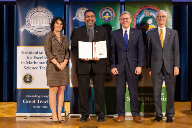 Jamil Siddiqui holds a Presidential Award for Excellence in Mathematics and Science Teaching while posing for a photo with Karen Marrongelle, a National Science Foundation director (from left), Siddiqui, Kelvin K. Droegemeier, director of the White House Office of Science and Technology Policy, and F. Fleming Crim, National Science Foundation chief operating officer.