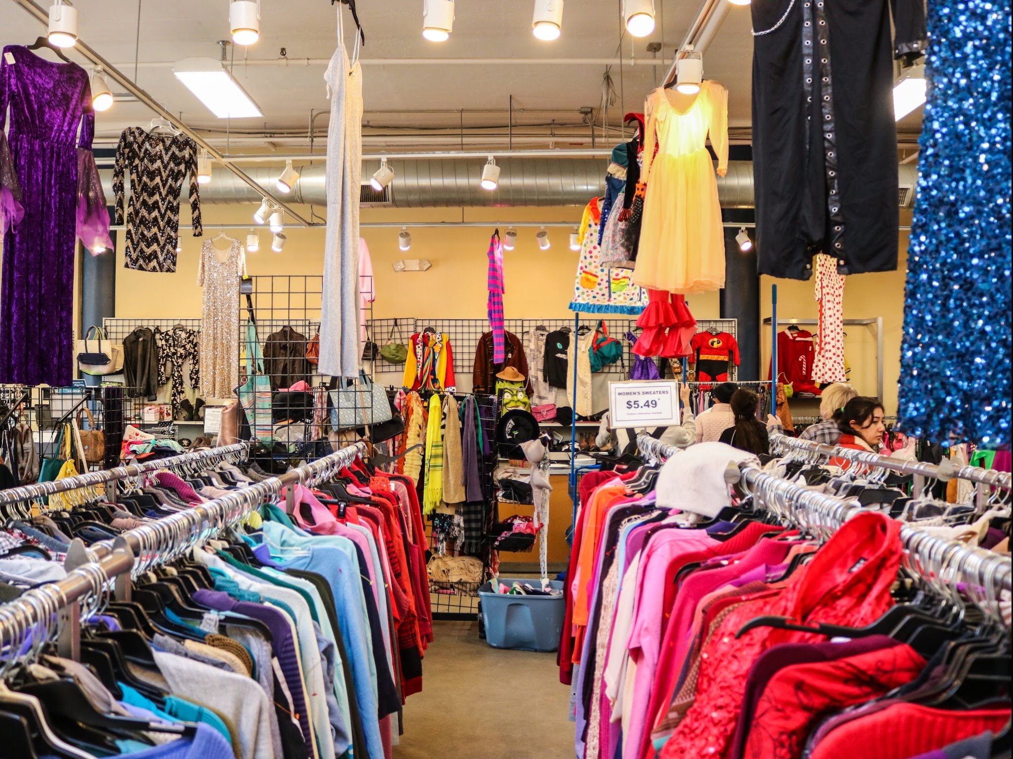 Racks of colorful clothing on display in Goodwill