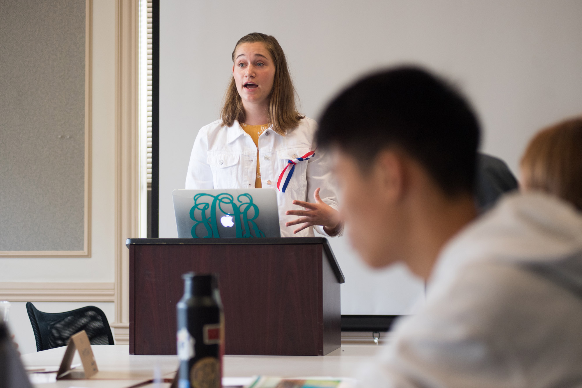 A student stands at a podium in class acting as president of revolutionary France’s 1791 National Assembly