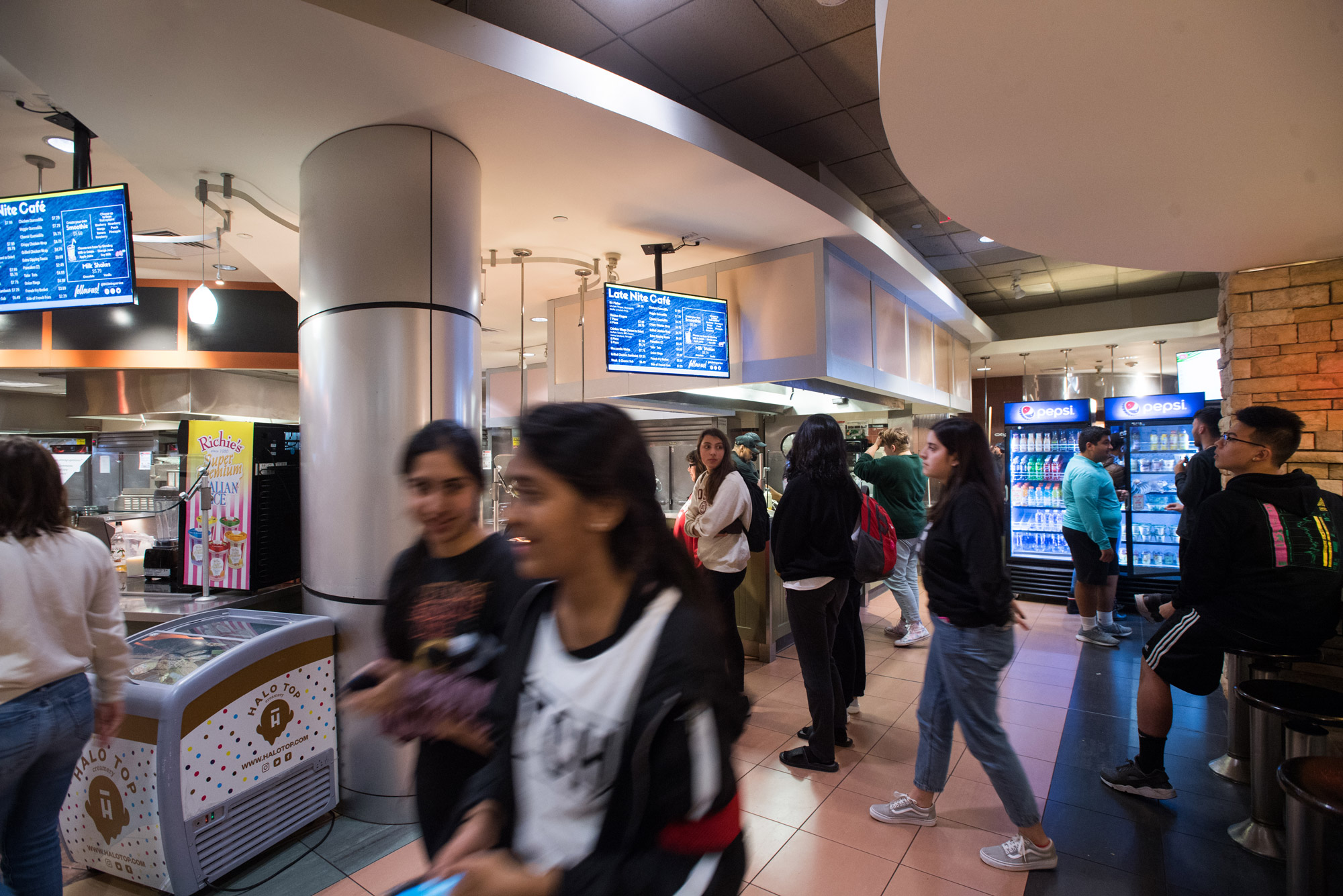 students mill about the late night cafe on west campus