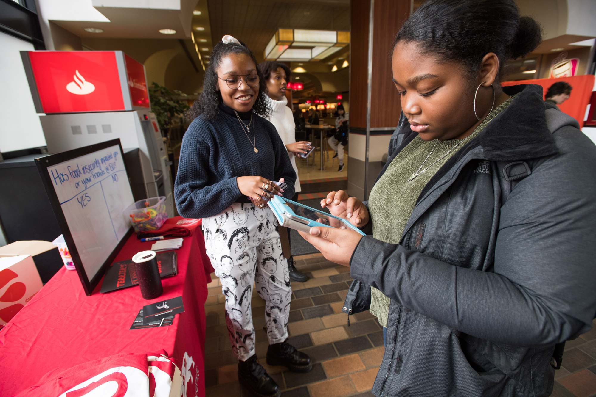 Montiah Norton (CAS’21) signs up on her phone to donate a meal to Terrier Meal Share