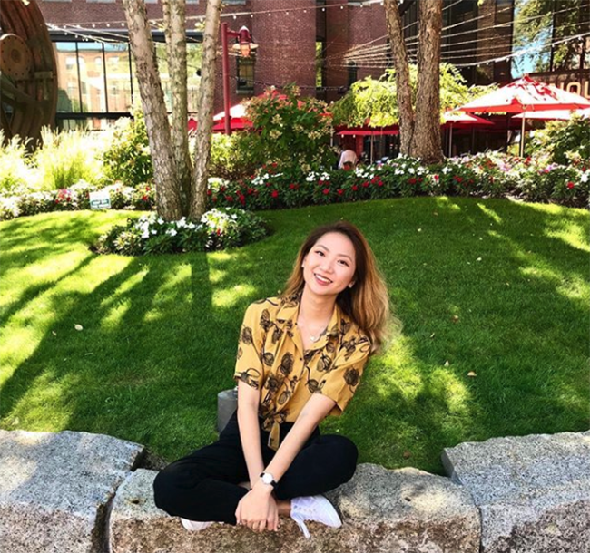 Lauren Baik sitting outside on the BU campus