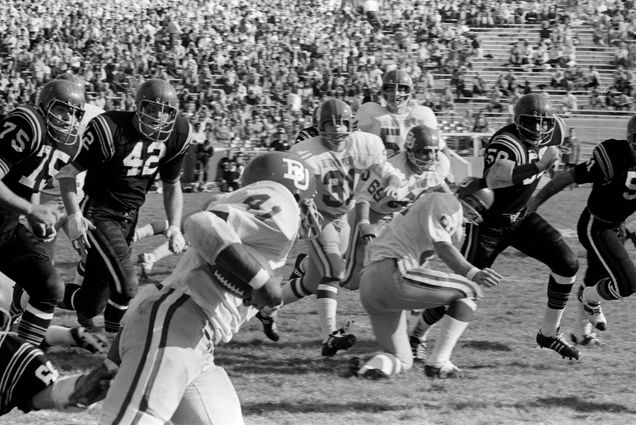 A Boston University football player runs the ball in the 1969 Pasadena Bowl game.