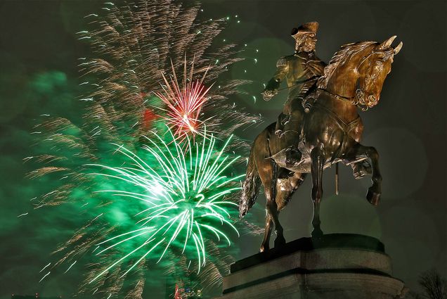 The Boston First Night fireworks explode in the sky behind the George Washington statue in the Boston Public Garden.