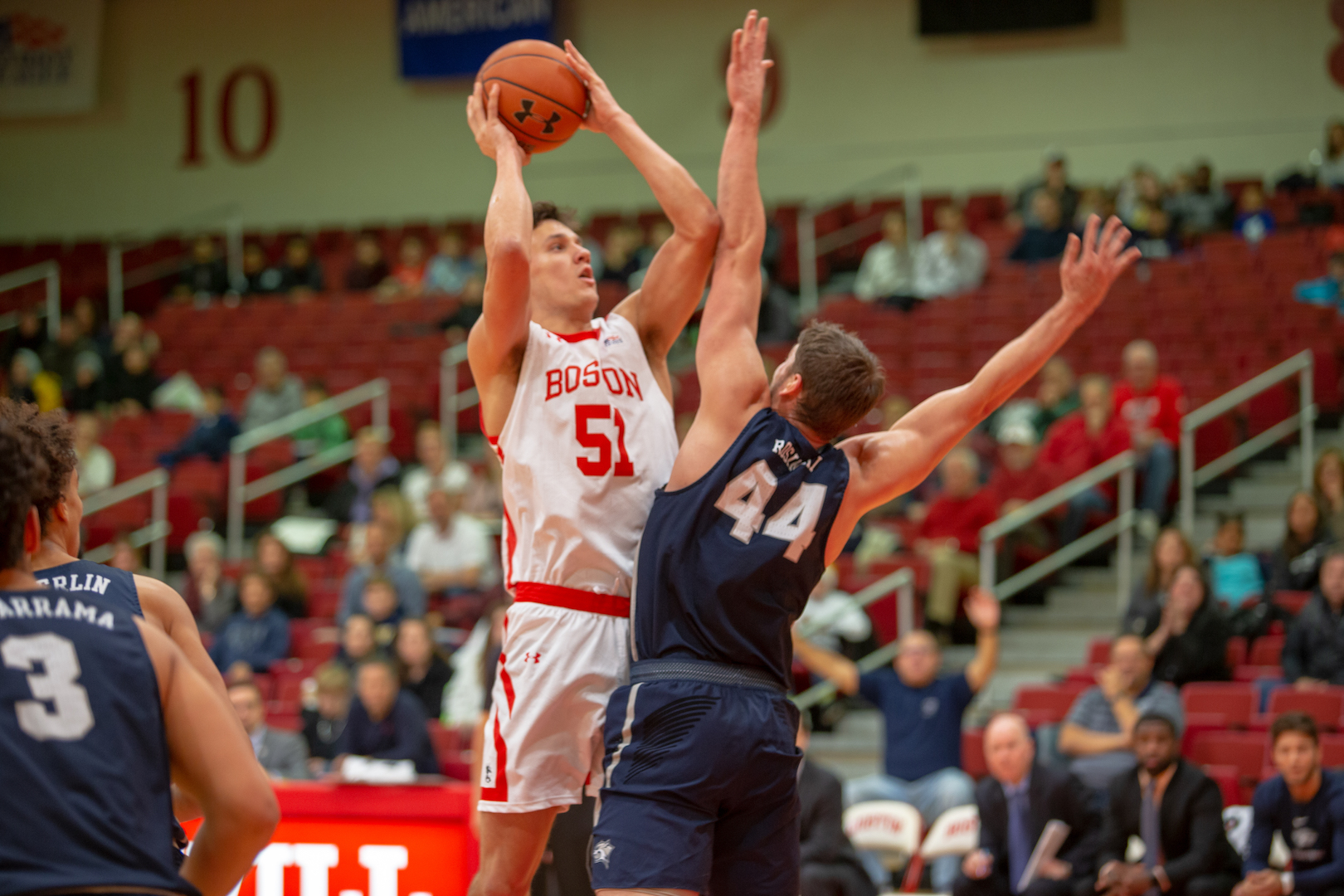 Max Mahoney, a mens basketball player, shoots the ball