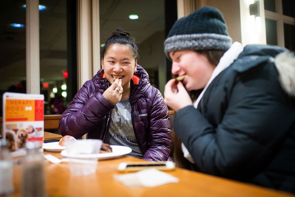 Grace Maddox (left, CAS 20) and Jessica Smith (CAS 20) enjoy latkes at the Hillel House on Tuesday, December 3, 2019