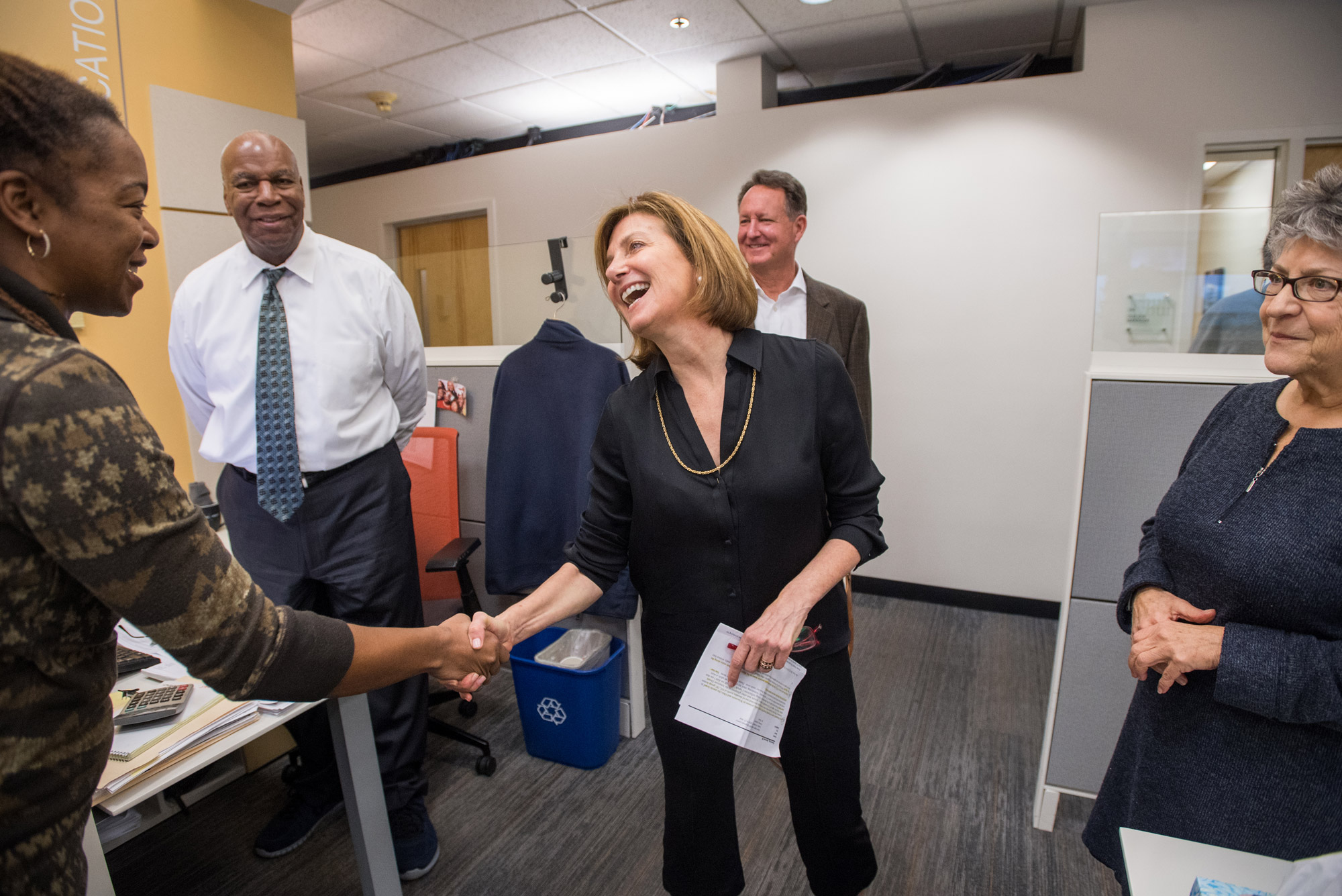 Margaret Low, new general manager for WBUR, shakes Quiana Scott-Ferguson's hand during her tour of the offices