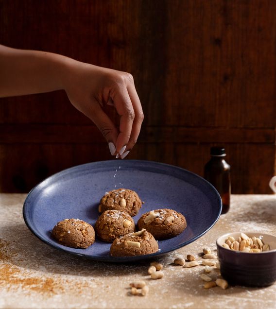 Jerrelle Guy's hand sprinkles a plate of cookies with sugar