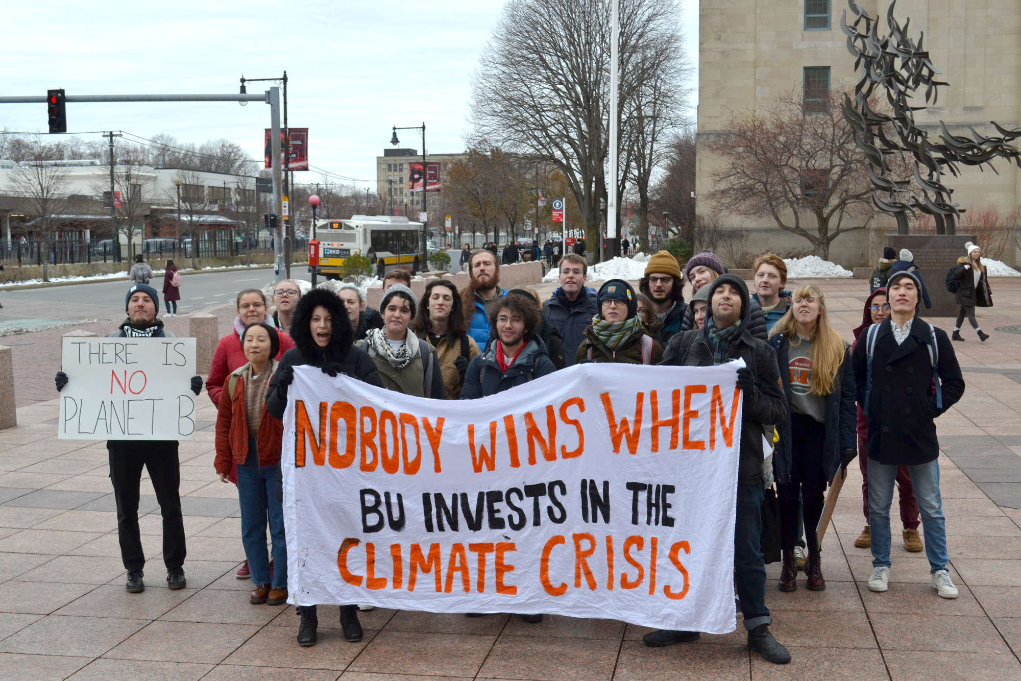 A group of Boston University students gathered in Marsh Plaza on Friday, December 6, 2019, before marching to Copley Square to join hundreds of protesters striking from school and work to demand an end to the climate crisis. They hold a sign that reads, "Nobody wins when BU invests in the Climate Crisis"
