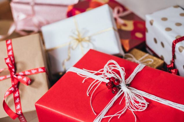 wrapped holiday presents in red, gold, and white