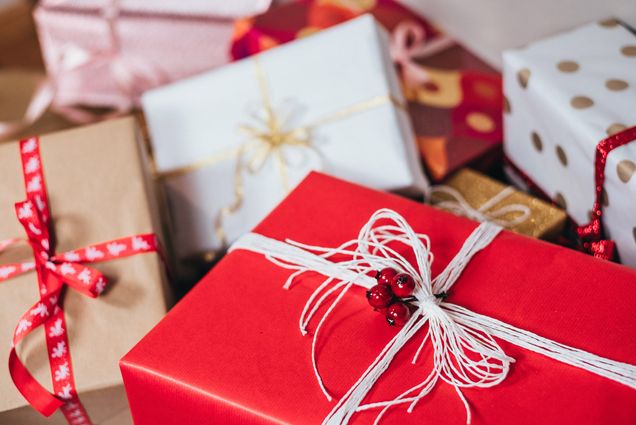 wrapped holiday presents in red, gold, and white