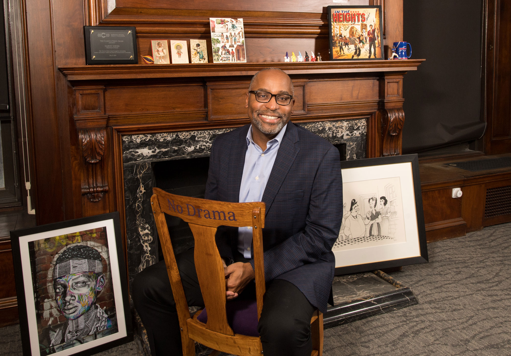 Harvey Young poses for a photo while sitting on a chair in his office 