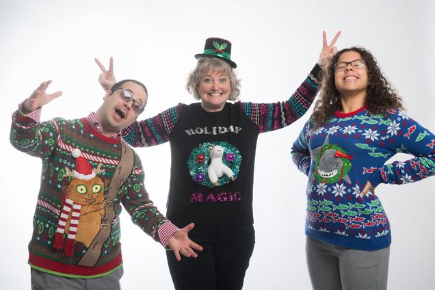 3 people pose in their ugly holiday sweaters