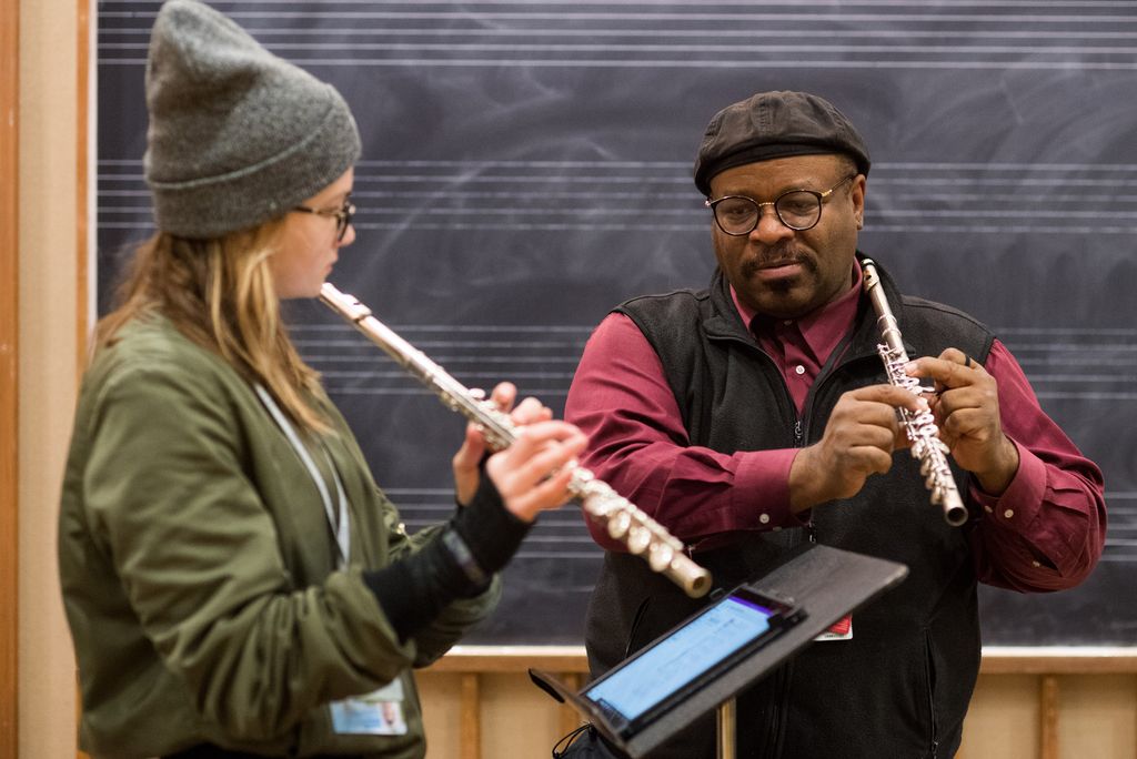 A photo of Lance Martin tutoring a student in improvisation on the flute.